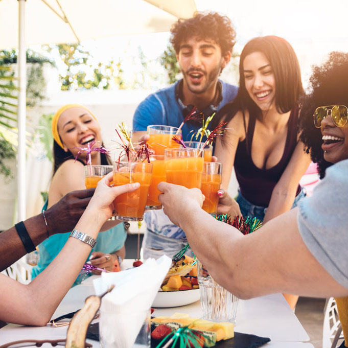 Young multiracial friends toasting beer at barbecue garden party - Young cheerful people cheering with cocktails on summer time